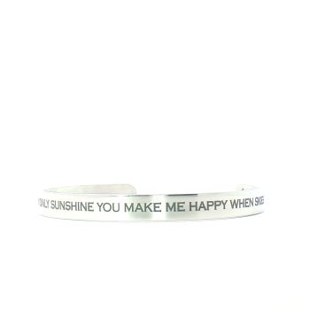 The “You Are My Sunshine” Engraved Bangle is a silver bracelet featuring the message YOU MAKE ME HAPPY WHEN SKIES on its surface, shown against a white background.