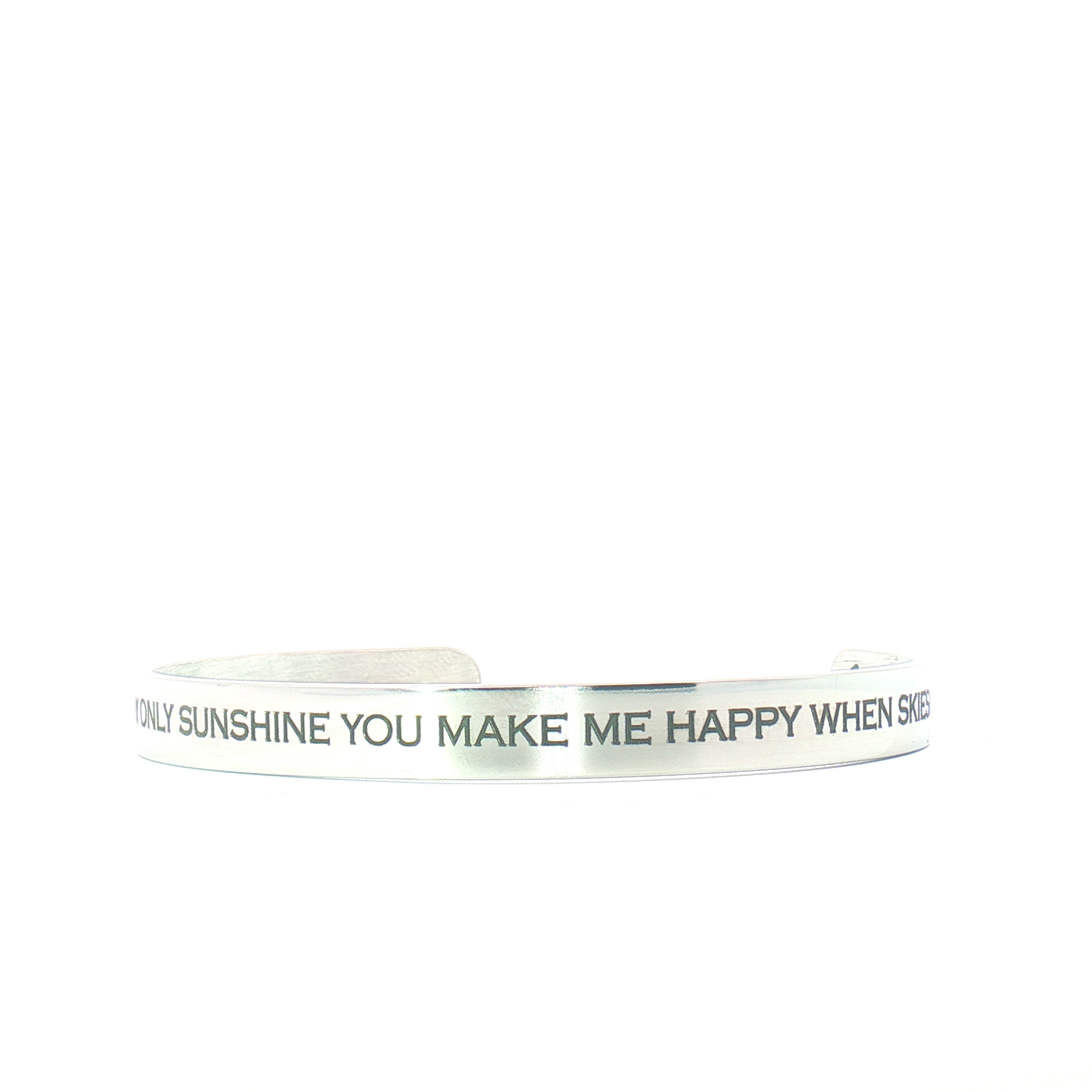 The “You Are My Sunshine” Engraved Bangle is a silver bracelet featuring the message YOU MAKE ME HAPPY WHEN SKIES on its surface, shown against a white background.