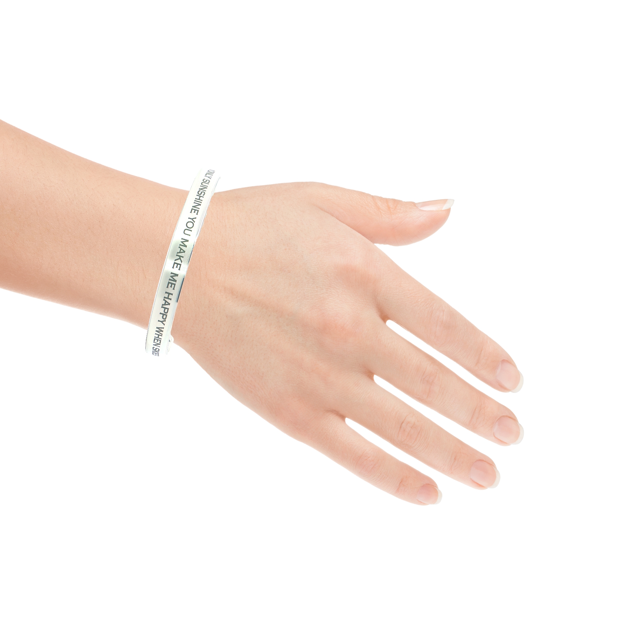 A left hand with light skin wears the “You Are My Sunshine” Engraved Bangle, a thin white bracelet with black text, against a plain white background.