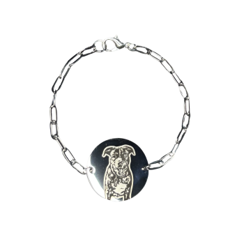 The “Forever Friend” Custom Pet Portrait Bracelet features a silver chain with elongated oval links, a lobster clasp, and a round pendant custom engraved with a detailed dog illustration, displayed on a plain white background.